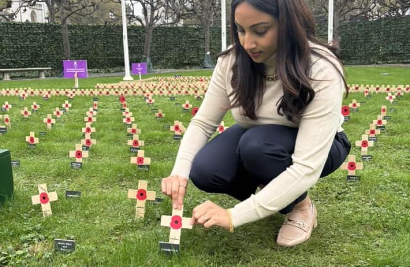 Shivani Raja MP placing a poppy in the Gardens of Westminster