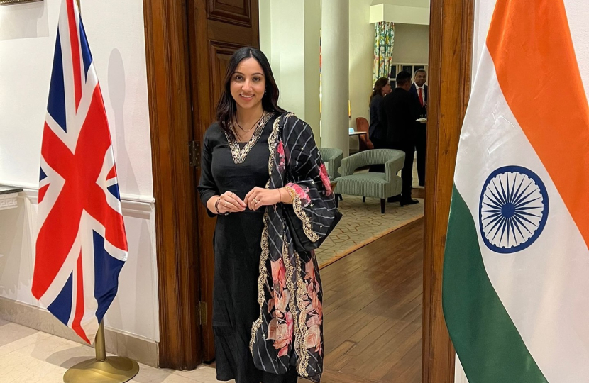 Shivani Raja MP stood between a British and an Indian flag.