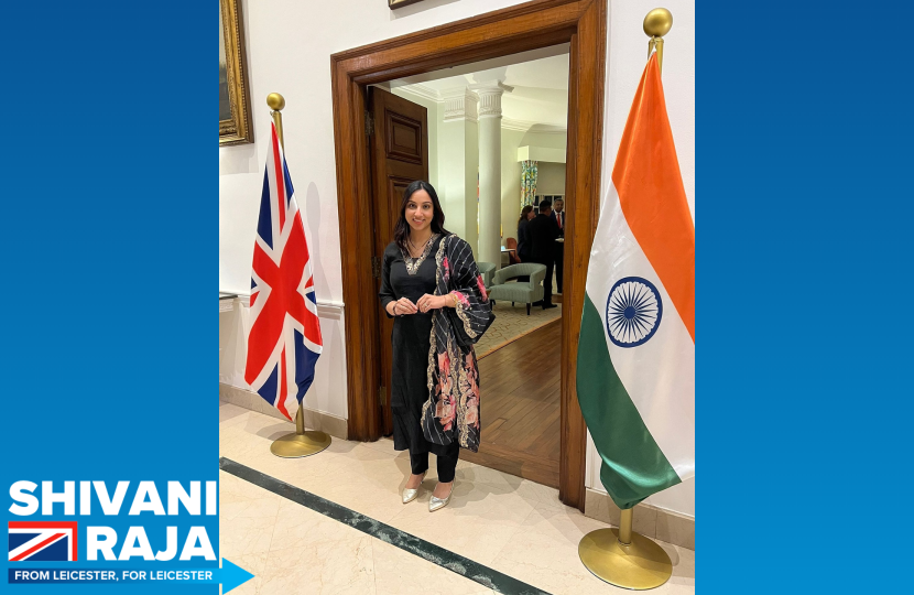 Shivani Raja MP stood between a British and an Indian flag.