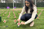 Shivani Raja MP placing a poppy in the Gardens of Westminster