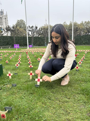 Shivani Raja MP placing a poppy in the Gardens of Westminster