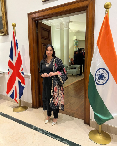 Shivani Raja MP stood between a British and an Indian flag.